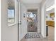 Inviting entryway featuring a white security door and a view of the kitchen at 10414 N 105Th Ave, Sun City, AZ 85351
