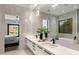 Modern bathroom with dual sinks, sleek countertops, and a large mirror at 10819 E Butherus Drive --, Scottsdale, AZ 85255