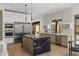 Sleek modern kitchen with stainless steel appliances and waterfall island and access to the outside at 10819 E Butherus Drive --, Scottsdale, AZ 85255