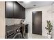 Modern laundry room featuring sleek cabinetry, updated appliances, and a sink for added convenience at 10819 E Butherus Drive --, Scottsdale, AZ 85255