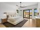 Bright main bedroom featuring a ceiling fan and sliding doors to a private outdoor living space at 10819 E Butherus Drive --, Scottsdale, AZ 85255