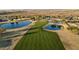 Aerial view of the golf course with ponds surrounded by desert landscape at 11034 E Natal Ave, Mesa, AZ 85209