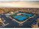 Aerial view of community featuring tennis courts, well manicured landscaping, and ample parking at 11034 E Natal Ave, Mesa, AZ 85209