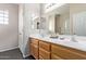 Dual sink bathroom featuring modern fixtures and wood cabinets at 11034 E Natal Ave, Mesa, AZ 85209