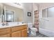 Bathroom featuring a vanity with sink, toilet, and a shower-tub combo with curtain at 11034 E Natal Ave, Mesa, AZ 85209