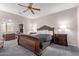 Spacious main bedroom with a large carved-wood bed frame and a separate office nook at 11034 E Natal Ave, Mesa, AZ 85209