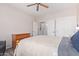 This bedroom has wood floors, a ceiling fan, and access to a laundry room at 11034 E Natal Ave, Mesa, AZ 85209