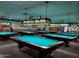 This billiards room is spacious and includes multiple tables and lighting at 11034 E Natal Ave, Mesa, AZ 85209