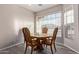 Cozy dining area featuring wood-look floors and a window overlooking the yard at 11034 E Natal Ave, Mesa, AZ 85209
