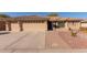 Charming single-story home featuring a three-car garage and a well-maintained desert landscaped front yard at 11034 E Natal Ave, Mesa, AZ 85209