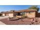 Charming home with easy-care desert landscaping in the front yard and a three car garage at 11034 E Natal Ave, Mesa, AZ 85209