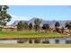 Scenic view of the golf course overlooking a pond with mountain views at 11034 E Natal Ave, Mesa, AZ 85209