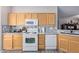 Well-equipped kitchen with appliances, tile backsplash, and wood cabinets at 11034 E Natal Ave, Mesa, AZ 85209