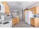 Galley kitchen with light wood cabinets, granite countertops, tile backsplash, and stainless steel appliances at 11034 E Natal Ave, Mesa, AZ 85209