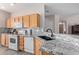 Bright kitchen featuring stainless steel appliances, wood cabinets, and speckled granite countertops at 11034 E Natal Ave, Mesa, AZ 85209