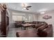 Living room featuring wood-look floors and comfortable brown leather furniture at 11034 E Natal Ave, Mesa, AZ 85209