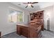 Dedicated home office featuring a large desk and custom wooden shelving at 11034 E Natal Ave, Mesa, AZ 85209
