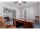 Comfortable home office space with a large desk and chair at 11034 E Natal Ave, Mesa, AZ 85209