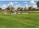 A scenic pond with a waterfall feature and grassy field at 11034 E Natal Ave, Mesa, AZ 85209