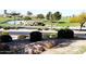 Landscaped view of the pond and putting green, a relaxing community space at 11034 E Natal Ave, Mesa, AZ 85209