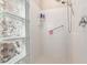 White-tiled shower with glass block window providing natural light at 11034 E Natal Ave, Mesa, AZ 85209