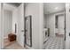 Hallway view leading to laundry room showcasing tile flooring, a washer, dryer and linen storage at 11172 N San Clemente St, Surprise, AZ 85388