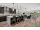 Bright kitchen showcasing a large island, modern appliances, and seamless flow into the dining and living areas with outdoor views at 11172 N San Clemente St, Surprise, AZ 85388