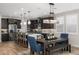 Spacious kitchen with seating at the island, stainless steel appliances, and open dining area with view of the backyard at 11172 N San Clemente St, Surprise, AZ 85388