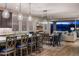 Bright, open kitchen featuring a large island with pendant lighting, modern appliances, and seamless flow into the living area at 11172 N San Clemente St, Surprise, AZ 85388