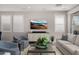 Comfortable living room featuring plantation shutters, modern entertainment center, and stylish furnishings at 11172 N San Clemente St, Surprise, AZ 85388