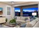 Cozy living room with comfortable seating, a large sliding glass door to an outdoor patio, and a view of the mountains at 11172 N San Clemente St, Surprise, AZ 85388