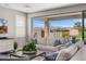 Bright living room featuring comfortable seating, a large sliding glass door leading to a backyard patio, and mountain views at 11172 N San Clemente St, Surprise, AZ 85388