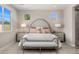 Elegant bedroom with a cushioned headboard, bench, neutral tones and plenty of natural light at 11172 N San Clemente St, Surprise, AZ 85388