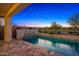 Features a luxurious pool with a waterfall feature, perfect for outdoor entertainment and relaxation at twilight at 11172 N San Clemente St, Surprise, AZ 85388