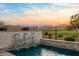 Beautiful backyard pool with rock waterfall feature overlooking an incredible golf course and mountain views at 11172 N San Clemente St, Surprise, AZ 85388