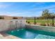 This pool boasts a rock waterfall feature, enhanced by a manicured golf course and scenic mountain backdrop at 11172 N San Clemente St, Surprise, AZ 85388