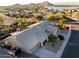 Scenic aerial view of a desert home in a golf community with access to a lake at 11182 S Hopi Dr, Goodyear, AZ 85338