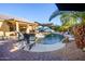 Inviting backyard with pool, lounge chairs and patio, ideal for outdoor entertaining and relaxation at 11182 S Hopi Dr, Goodyear, AZ 85338