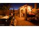 An outdoor entertainment area with a trellis, lounge chairs, and potted flowers at 11182 S Hopi Dr, Goodyear, AZ 85338