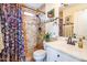 Well-lit bathroom featuring a mosaic tiled shower, stylish vanity and bright natural light at 11182 S Hopi Dr, Goodyear, AZ 85338