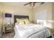 Cozy bedroom featuring a bed with a grey headboard, yellow pillows, and neutral walls at 11182 S Hopi Dr, Goodyear, AZ 85338