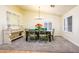 A quaint dining room featuring a table with 6 chairs, a light fixture, and a large window at 11182 S Hopi Dr, Goodyear, AZ 85338