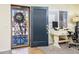 This entryway features a security door and an open door into an office area with a desk at 11182 S Hopi Dr, Goodyear, AZ 85338