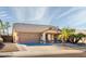 Inviting single-story home with desert landscaping and a two-car garage at 11182 S Hopi Dr, Goodyear, AZ 85338