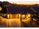 Charming single-story home with a well-maintained front yard, illuminated by the warm glow of sunset at 11182 S Hopi Dr, Goodyear, AZ 85338