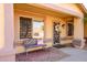 Charming front porch with a bench, decorative wreath, and well-maintained landscaping at 11182 S Hopi Dr, Goodyear, AZ 85338