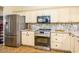 A bright kitchen showcases white cabinets, stainless steel appliances, and granite countertops at 11182 S Hopi Dr, Goodyear, AZ 85338