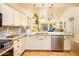 This gorgeous kitchen has a large countertop with three pendant lights, and stainless steel appliances at 11182 S Hopi Dr, Goodyear, AZ 85338