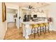 Bright kitchen with a spacious island, granite countertops, stainless steel appliances, and stylish bar stools at 11182 S Hopi Dr, Goodyear, AZ 85338