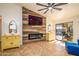 Cozy living room with custom fireplace and a large sliding glass door that provides great natural light at 11182 S Hopi Dr, Goodyear, AZ 85338